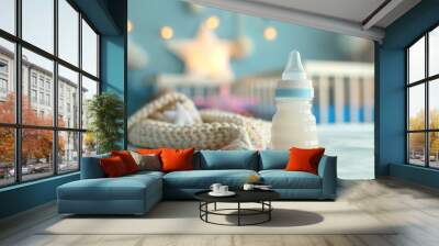 A bottle of baby formula sits on a bed next to a blanket Wall mural