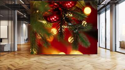 Close-up of Christmas tree with red balls and bokeh in the background. Background with copy space for holiday design. Wall mural