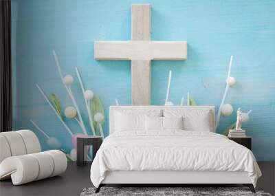 Cross and easter eggs on a blue wood background with copy space Wall mural