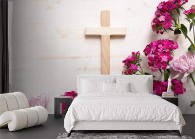 Wood Christian cross with border of pink flwoers on a white wood background with copy space Wall mural