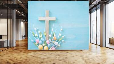 Wood cross with easter egg decorations on a blue wood background with copy space Wall mural