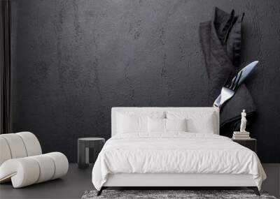 Empty dark stone table with napkin, fork and knife Wall mural