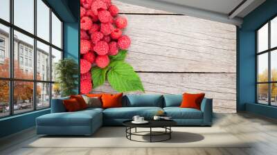 Fresh ripe raspberries on wooden table Wall mural