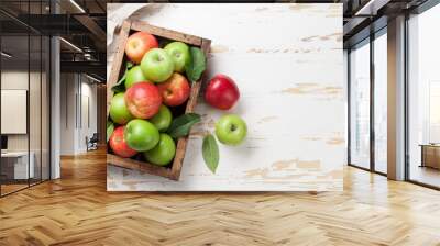 Green and red apples in wooden box Wall mural