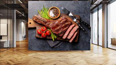 Medium rare grilled Tomahawk beef steak with asparagus Wall mural