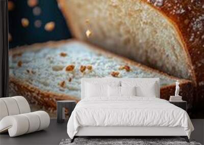 Freshly baked loaf of bread being sprinkled with oats on a wooden cutting board Wall mural