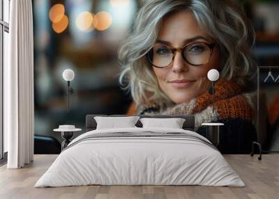 Stylish senior woman with grey hair wearing glasses in cafe Wall mural