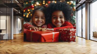 Two happy children smiling and holding christmas gift Wall mural