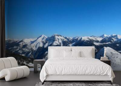 a panorama of the snow-covered mountains of the Alps in winter 2023 Wall mural