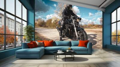 motorcyclist dressed in black sits on his black motorcycle Wall mural