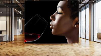 African woman smelling red wine aroma. Wall mural