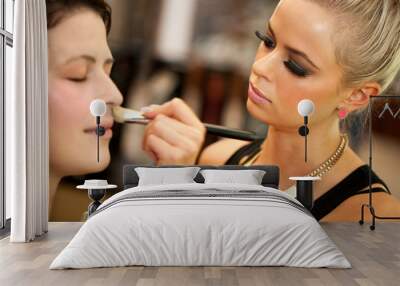 attractive female make up artist at work. Wall mural