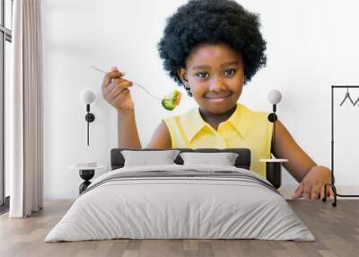 little black girl eating healthy vegetable meal. Wall mural