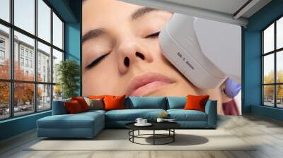 Woman receiving high intensity focused ultrasound treatment on face. Wall mural