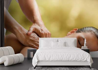 Young woman enjoying massage in spa. Wall mural