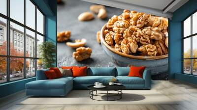 Bowl filled with shelled walnuts on a rustic table, highlighting the healthy and nutritious snack in a simple setting. Wall mural