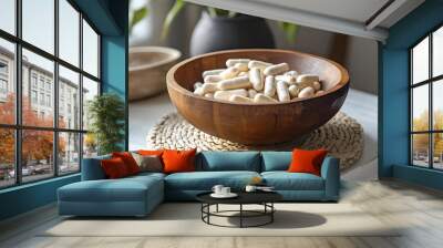 Wooden bowl of dietary supplement capsules on table
 Wall mural