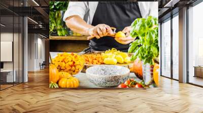  mid section of chef cleaning potatoes for pumpkin soup  Wall mural