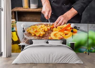 Chef cutting fresh and delicious pumkin and vegetables for cooking soup Wall mural