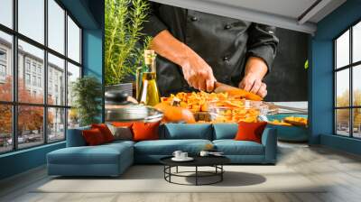 Chef cutting fresh and delicious pumkin and vegetables for cooking soup Wall mural