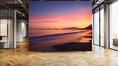 early morning seascape over beach with silhouetted coastline and colourful dawn sky Wall mural