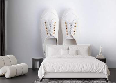 women's white sneakers on a white background. view from above. Wall mural