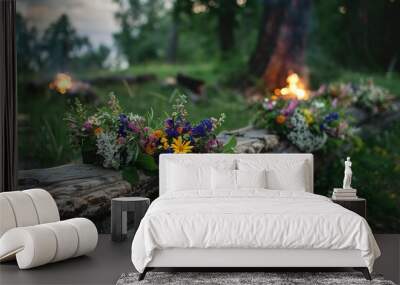 Midsummer night celebration. Wooden log with flower crown and fire in lush green rural landscape.. Generative AI Wall mural