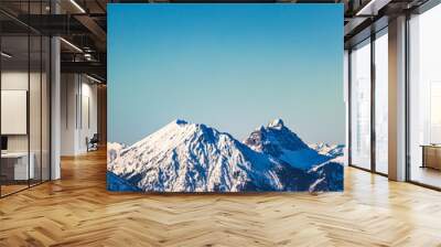 landscape of snow covered mountaintops with clear blue sky Wall mural