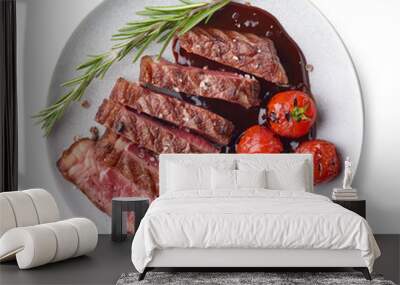 Grilled sliced Beef Steak with sauce, tomatoes and rosemary on a white plate Isolated on white background top view Wall mural