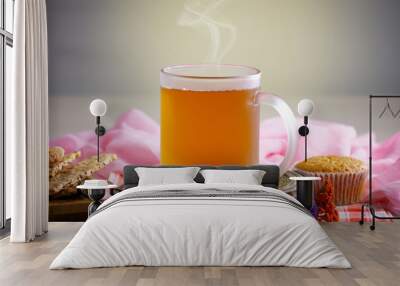 Sweet, hot tea with dry tea leaves, on an old background. Wall mural