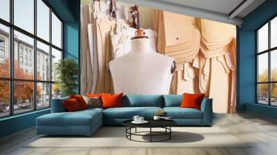 Mannequin in bespoke tailor studio against cardboard sewing patterns. Wall mural