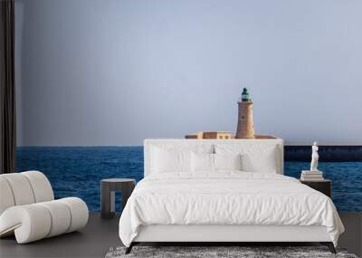 Lighthouse in harbor entrance Wall mural