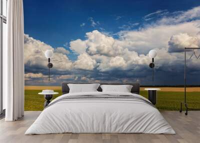 Storm sky over agricultural fields. Wall mural