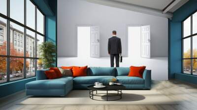 backview portrait of businessman in front of two doors Wall mural