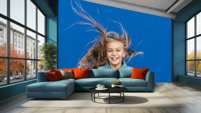 Little girl with blonde hair spinning outside Wall mural