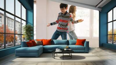 Two kids dancing on the table Wall mural