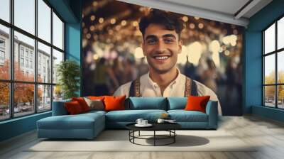 Handsome young man in traditional attire at Oktoberfest, smiling warmly amidst a bustling crowd and festive decorations in a concert hall during the celebrated beer festival. Wall mural