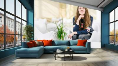 Young attractive woman with a cup of tea in a cafe.  Smiling, gap teeth. Bright modern interior. PNatural unconventional beauty. Сommunication with riends, conversation, talk. Looks at the camera Wall mural