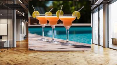 Close-up shot of glasses of cocktails on poolside Wall mural