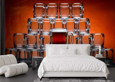 Close up view of arranged empty glasses and mug of beer on orange background Wall mural