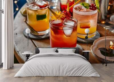 Close-up view of glasses with alcohol cocktails on wooden table Wall mural