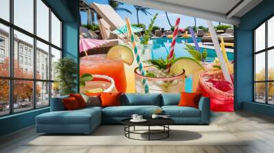 Close-up view of summer cocktails with straws at poolside Wall mural