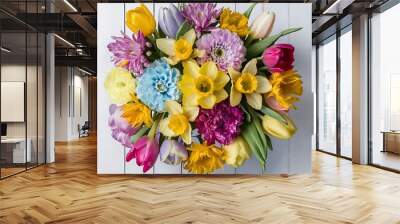 Colorful bouquet of spring flowers on white wooden background top view Wall mural