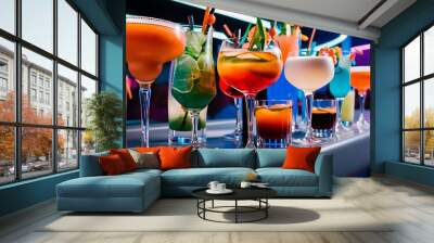 Rows of many tasty strong colorful orange green blue white cocktails shots shooters alcohol drink in glasses standing on bar of nightclub closeup on gray background, horizontal picture Wall mural