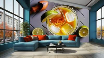 Top view of alcohol margarita cocktails with pieces of lime, ice cubes and wooden squeezer on grey tabletop Wall mural