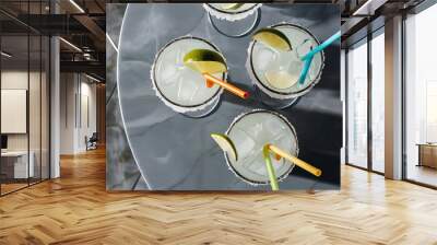 Top view of cold alcohol margarita cocktails with pieces of lime on grey tabletop Wall mural