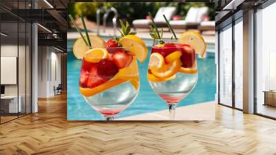 Two glasses with natural fruit refreshing beverage at poolside Wall mural