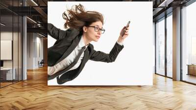 Businesswoman flying through the air checking her smartphone for urgent messages Wall mural