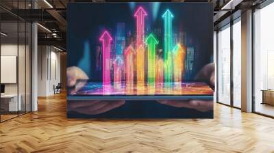 Hand holding tablet with rising arrows hologram, depicting growth and digital progress concept Wall mural