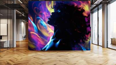 A young, beautiful black woman dancing at the club surrounded by the colorful lights. Rave, concert, party, event photography Wall mural